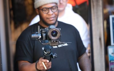 photo of man holding digital camera