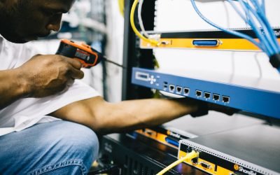 professional crop black technician working with hardware